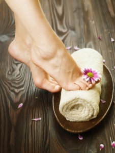 Beautiful Woman Feet with flower.Spa or pedicure concept